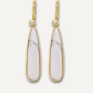 Howlite and white sapphire gemstone dangle earrings on cream background.