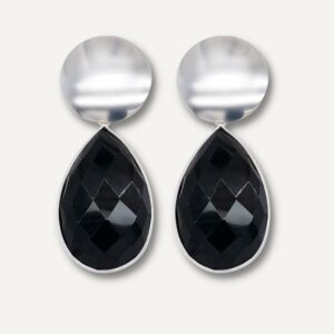Large black and silver drop earrings on cream background