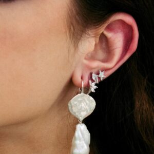 Model wearing a silver earring stack with diamond simulants.