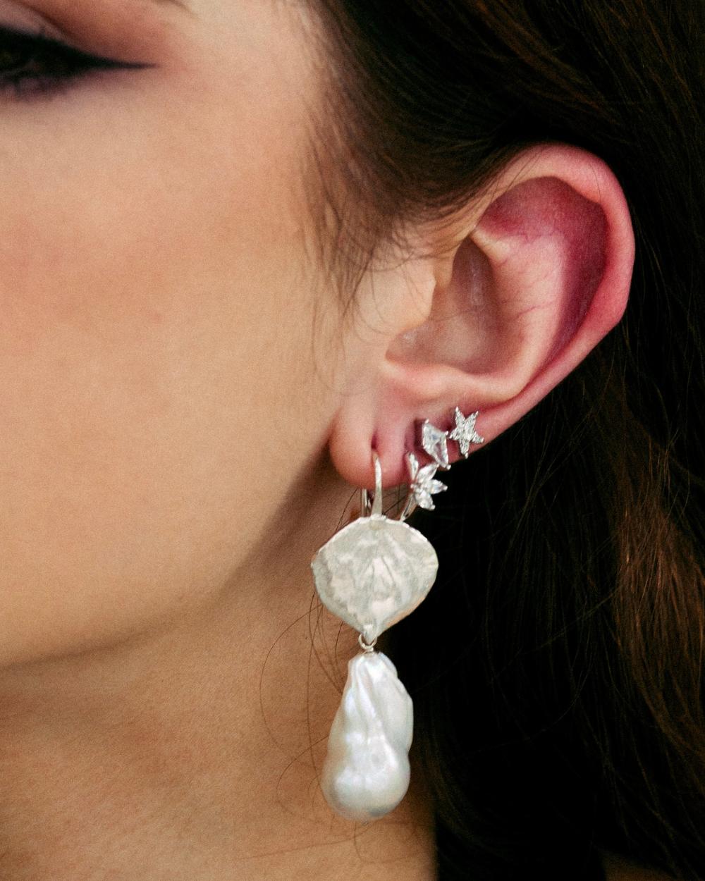 Model wearing a silver earring stack with diamond simulants.