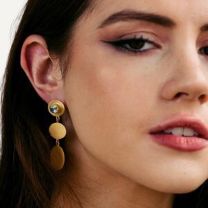 Gemstone earrings on dark haired model.