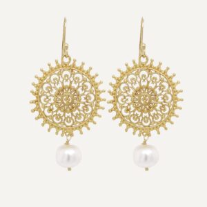 Statement earrings golden mandala shape with white baroque pearl drop on cream background.