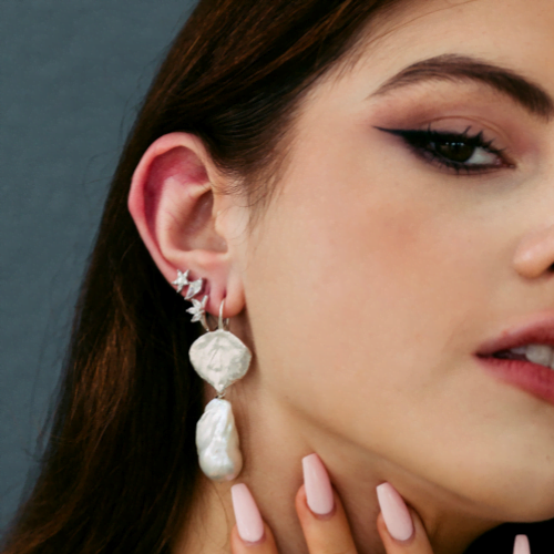 model wearing earring stack with large baroque pearl