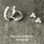 Diamond simulant hoops and stud earrings on grey tile background