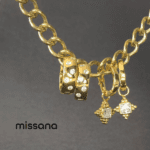 Diamond simulant gold hoop earrings on chain.